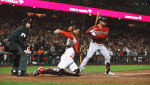 a baseball game is being played in front of a bank of america advertisement