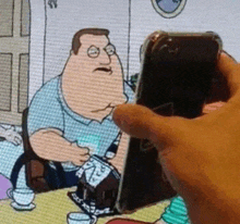 a person is holding a cell phone in front of a cartoon character