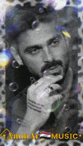 a black and white photo of a man with bubbles around him and the words ammar music below him