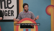 a man is standing in front of a sign that says " the ringer "