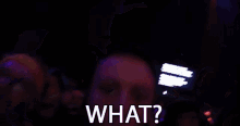 a man in a crowd says what in front of a purple background .
