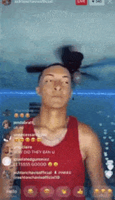 a man in a red tank top is looking at the camera