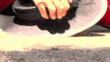 a close up of a person 's hands holding a circular object
