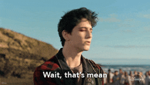 a young man says wait that 's mean in front of a crowd