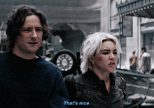 a man and a woman are standing next to each other and the man says that 's nice