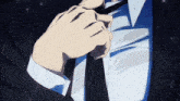 a man in a suit and tie is tying his tie .