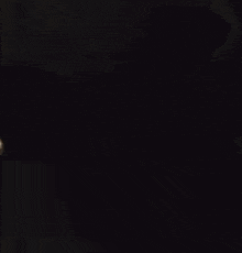 a man is holding another man in his arms in the dark