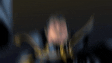 a blurry picture of a man in a cape with the letter o on it