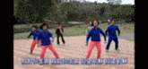a group of children in blue shirts and pink pants are dancing in a field
