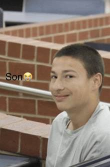 a boy with a smiley face and the word son below him