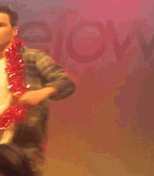 a man in a plaid shirt is dancing on a stage