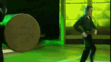 a man wearing headphones is dancing on a stage