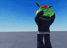 a person wearing a green hoodie with wings on it
