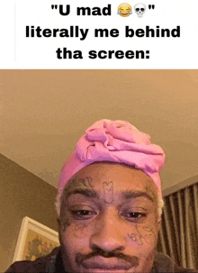 a man wearing a pink turban has a tattoo on his face