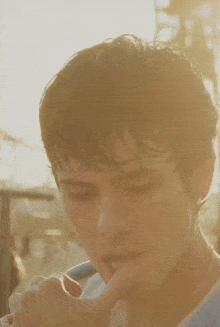 a close up of a man 's face with the sun shining on his hair