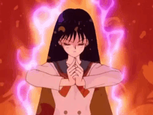 a girl in a sailor suit is holding her hands together in front of a red background .