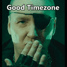 a man wearing a pirate eye patch is blowing a kiss with the words good timezone below him