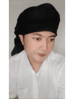 a man wearing a white shirt and a black headband looks at the camera