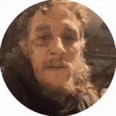a man with a beard has a tattoo on his face that says money .