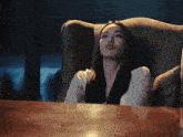 a woman is sitting in a chair with a leopard print