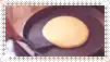 a pancake is being cooked in a skillet on a table .