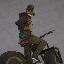 a man wearing a mask is riding a bike and waving