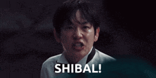 a man in a tuxedo is making a funny face and the word shibal is behind him