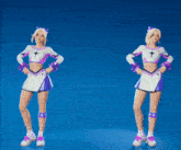 two cheerleaders are standing next to each other with their arms outstretched