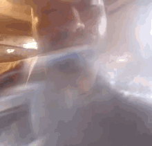a close up of a person 's face with smoke coming out of his mouth