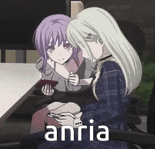 two anime girls are sitting next to each other at a table . one of the girls is holding a book .