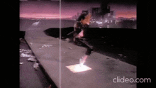 a man is walking down a sidewalk with a city in the background and the words clideo.com on the bottom right