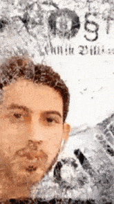 a man 's face is visible in a blurry photo with the word justice visible in the background