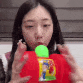 a woman is playing with a toy that says no
