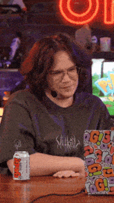 a man wearing glasses and a t-shirt that says ' smash ' on it sits in front of a laptop