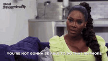 a woman is sitting on a couch with the words you 're not gonna be able to do that anymore
