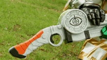a person holding a toy gun with a circle on it that says ' o ' on it