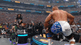 wrestlers in a stadium with the word wrestlemania on the screen