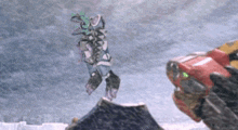 a robot is jumping in the air while another robot is standing in the snow .