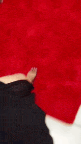 a woman standing on a red rug with a chegueeeeei sticker