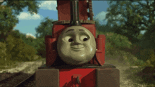 a red train with a smiley face on the front of it