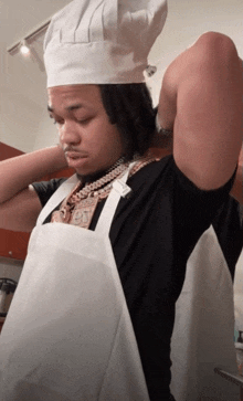 a man wearing a chef 's hat and apron has a necklace with the number 90