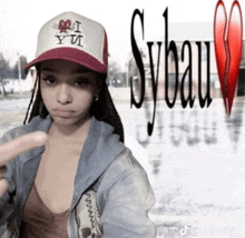 a girl wearing a hat that says sybau on it