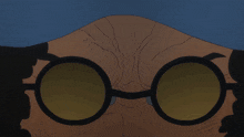 a close up of a person 's face with round glasses