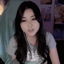 a woman wearing headphones and a t-shirt that says ' ns ' on it