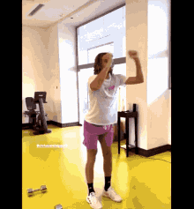 a woman flexes her muscles in a gym