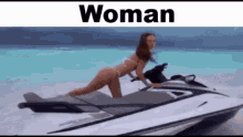 a woman is riding a jet ski on the beach .