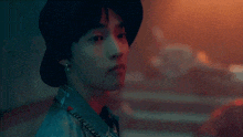a close up of a person wearing a hat and a denim jacket