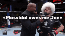 a man in a fur hat talks into a microphone with the words masvidal owns me joe above him