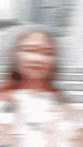 a blurred image of a person 's face with a gray background