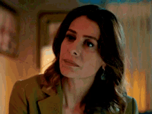 a close up of a woman wearing a green jacket